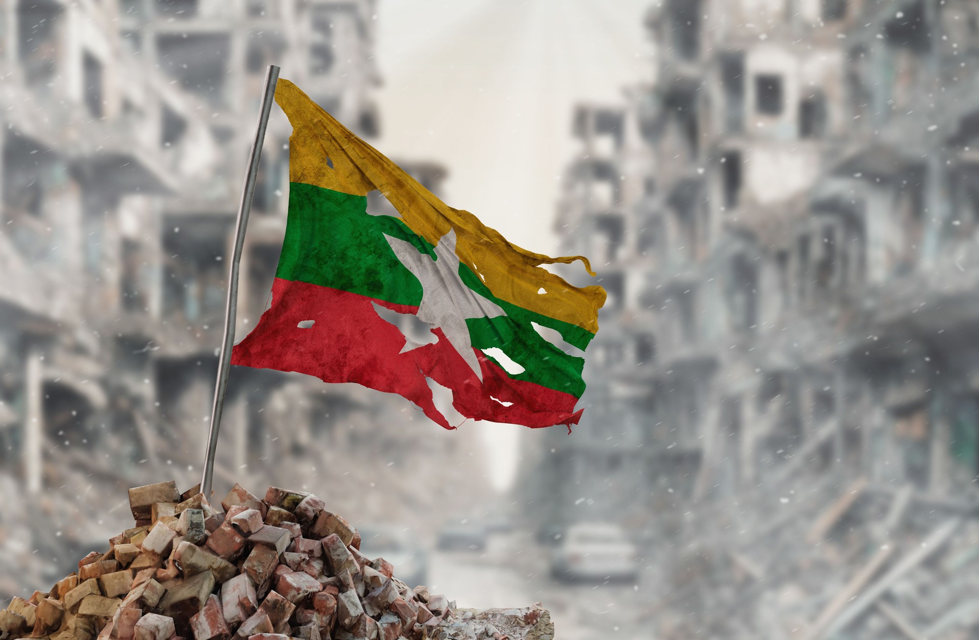 Dirty and torn Myanmar or Burma flag, symbol of resistance and victory. A scene of war and devastation, the ruins of a city destroyed by conflicts. 3D Rendering.